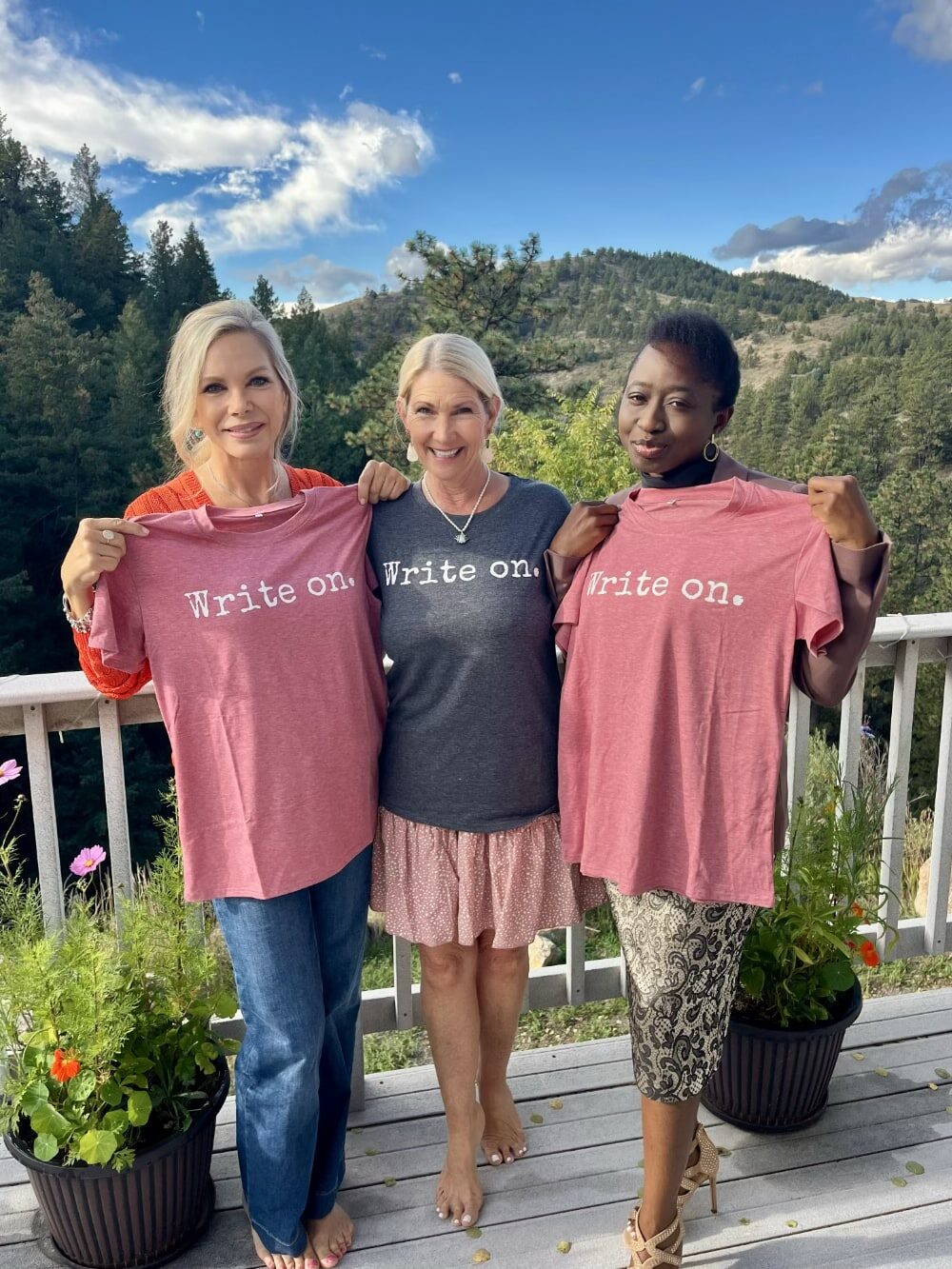 Authors wearing Write On shirts at a mountain retreat