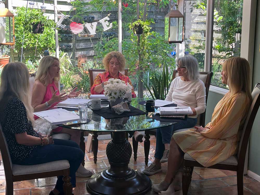 Lisa J teaching a small group of authors during a retreat